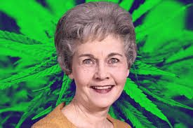 A woman with a marijuana leaf behind her.