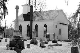 A black and white photo of an old church.